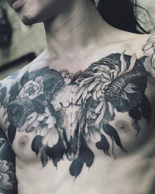 Chest tattoo by Kubrick Ho #KubrickHo #chesttattoo #sternumtattoo #chestpiecetattoo #skull #flowers #floral #deerskull #ramskull #blackwork #illustrative