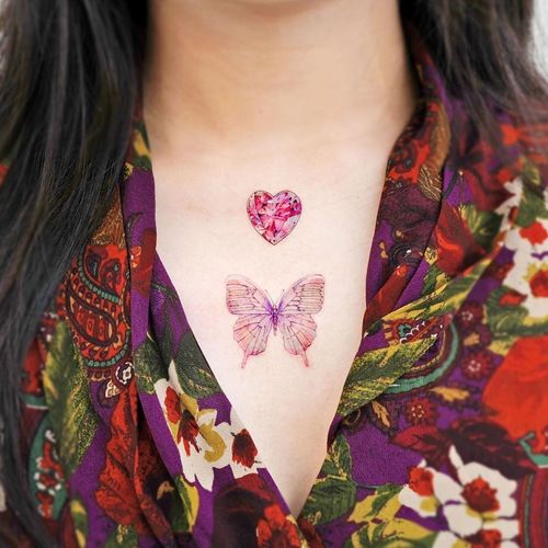 Chest tattoo by Song E #SongE #chesttattoo #sternumtattoo #chestpiecetattoo #butterfly #gem #diamond #butterfly #color #realism #realistic