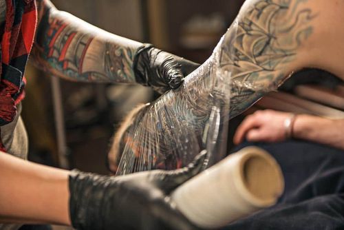 Your tattoo artist will wrap your new tattoo at the shop, which will protect it from dangerous bacteria entering your vulnerable skin in the first few days.